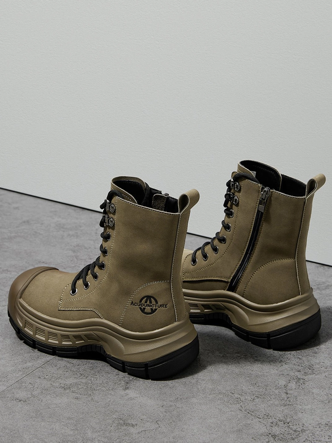 Olive green platform combat boots showing side zipper closure and chunky molded black sole