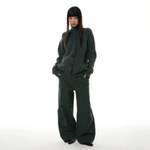 Olive green relaxed wide-leg workwear denim jeans styled with a cropped gray knit cardigan in a full-body front view