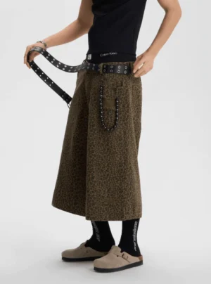 Female model wearing olive leopard print baggy cropped work shorts in a full streetwear outfit