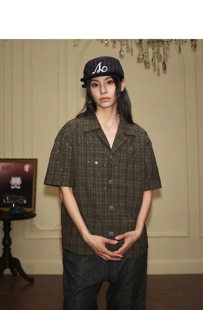 Front view of female model in olive rhinestone plaid camp collar short sleeve streetwear shirt and baseball cap