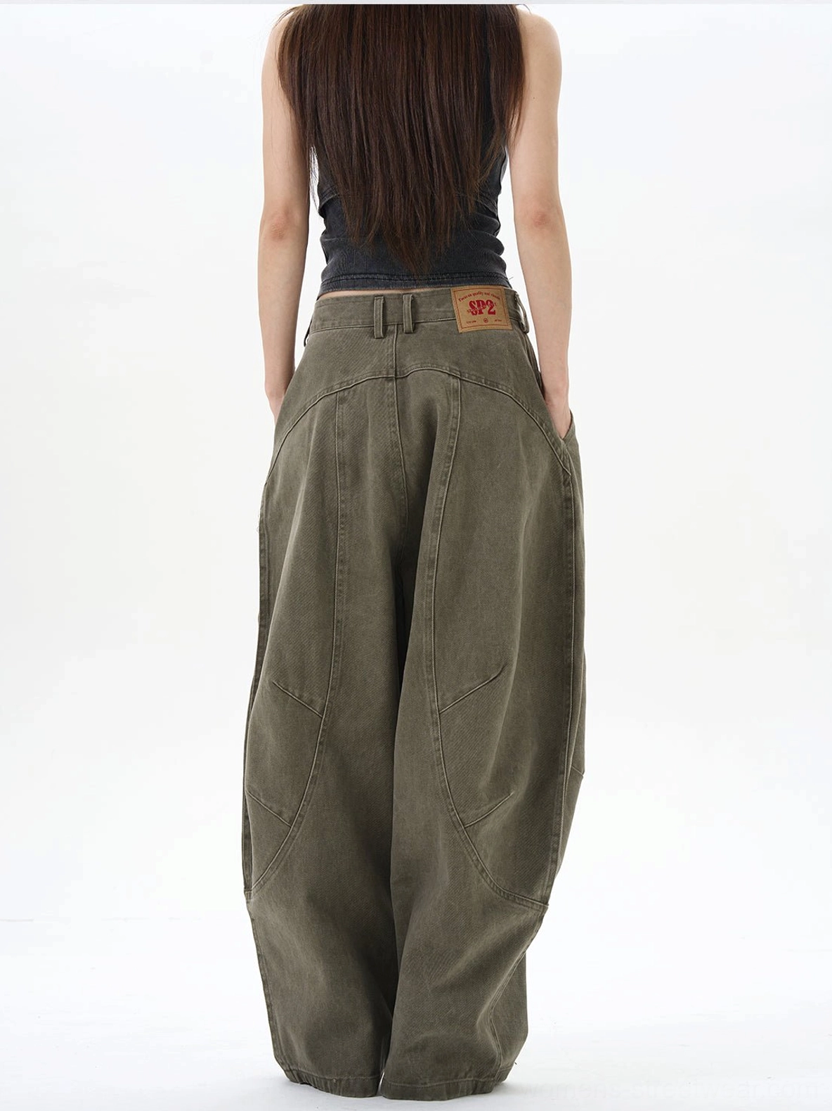 Back view of olive green wide-leg cargo pants showing relaxed tailoring and structured back seam details