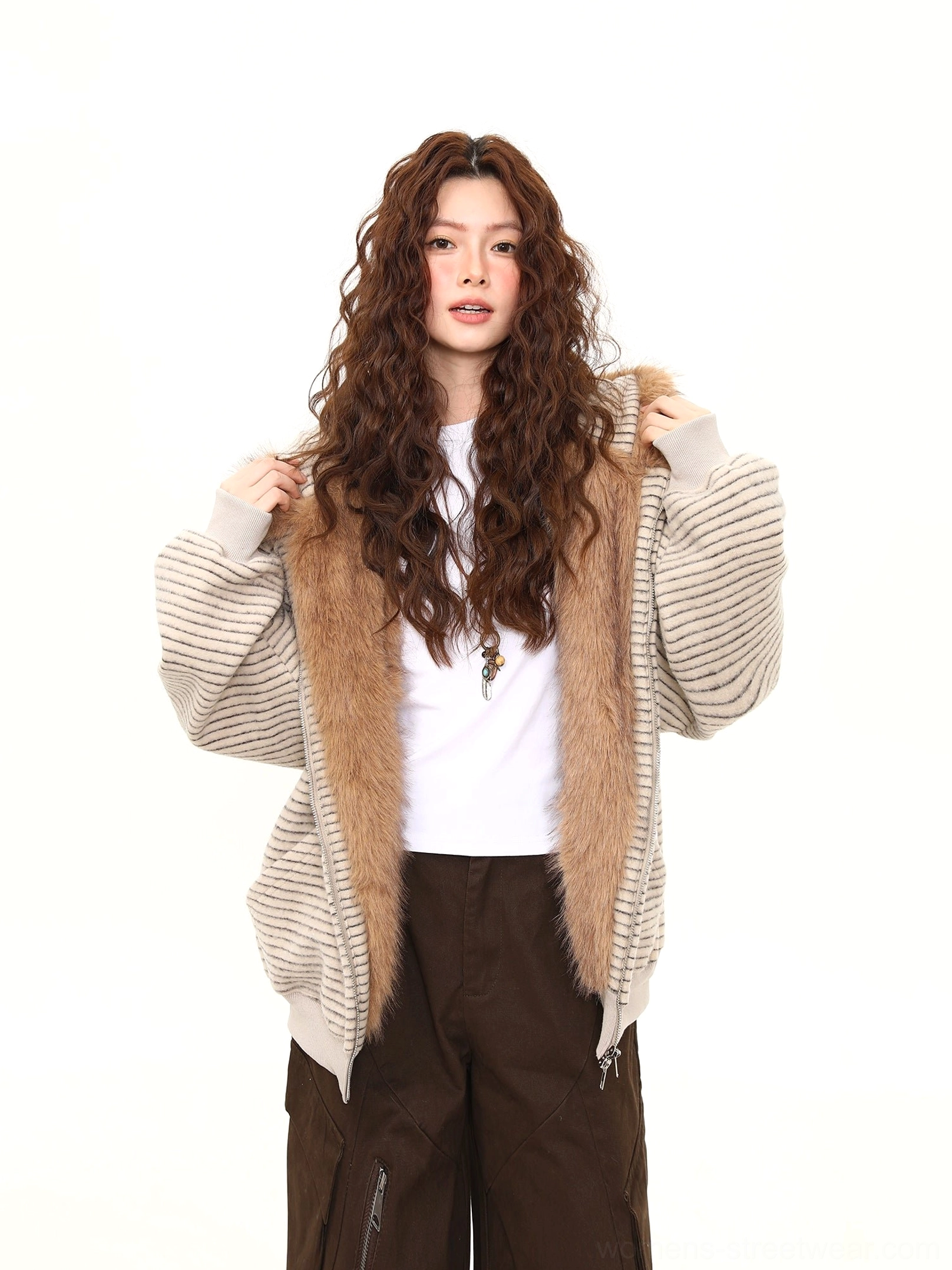 Front view of an open beige striped bunny-ear hoodie layered over a white tee with fluffy brown faux-fur hood trim and chest embroidery