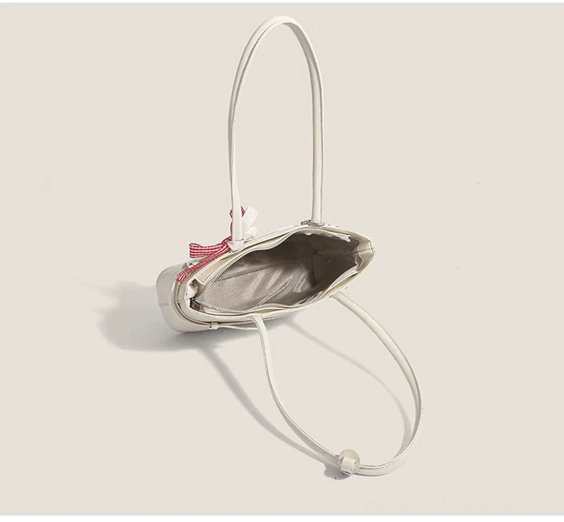 Open off-white cherry picnic baguette bag showing polyester interior lining, top zipper, ribbon decoration, and silver shoulder strap hardware
