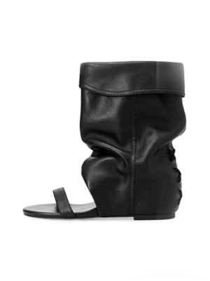 Black open-toe slouchy hidden-wedge sandal boots shown from the side with a ruched cuff, thong strap, and rear lace-up detail