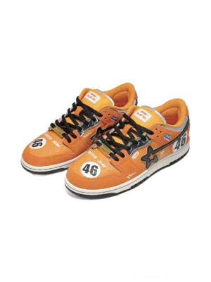 Pair of orange racing skate sneakers shown from an elevated front-side angle with black star panels, No. 46 toe and heel graphics, and black laces