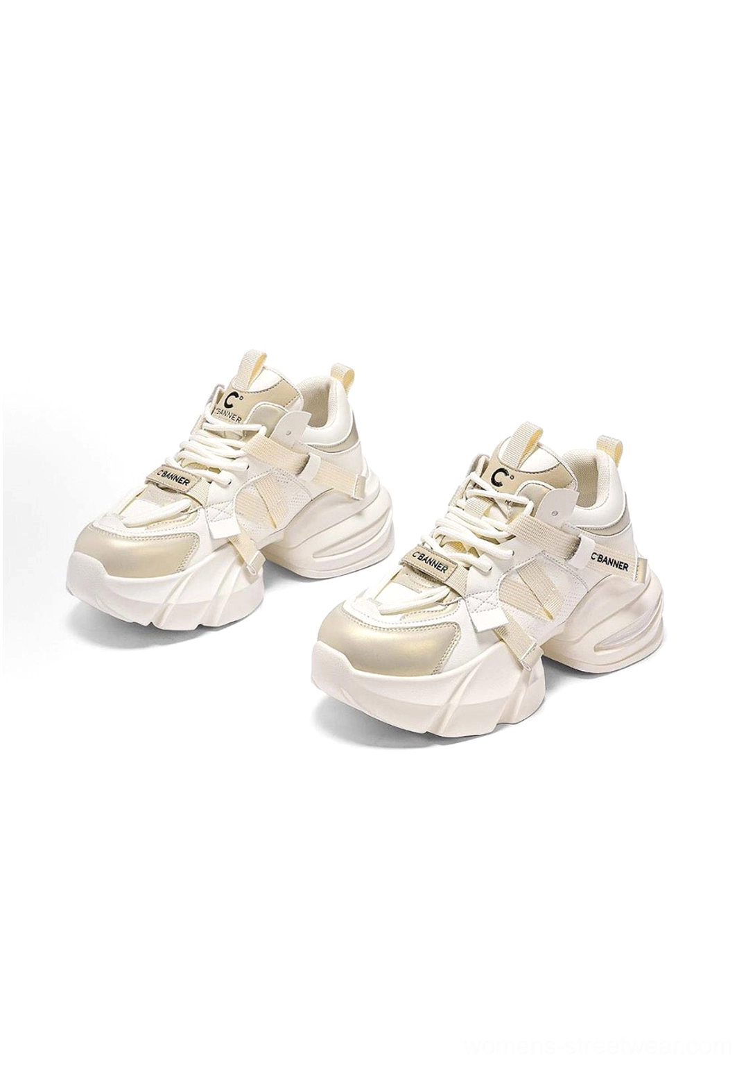 Overhead view of cream white chunky dad sneakers with lace-up fronts and champagne gold toe accents