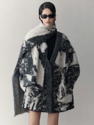 Front view of an oversized abstract black and cream ink print wool-blend cardigan with matching scarf, V-neck button front, fuzzy texture, and roomy pockets