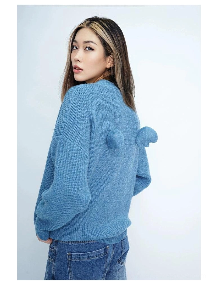 Oversized angel wing pom-pom fuzzy knit cardigan button front detail product view
