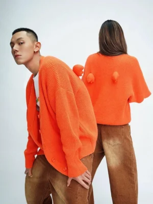 Orange oversized angel wing pom-pom fuzzy knit cardigan front and back view on fashion models