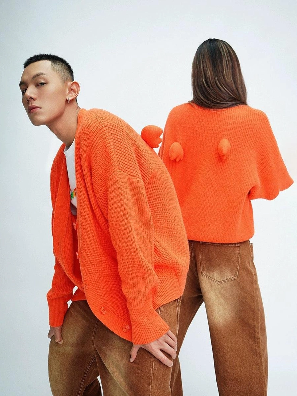 Orange oversized angel wing pom-pom fuzzy knit cardigan front and back view on fashion models