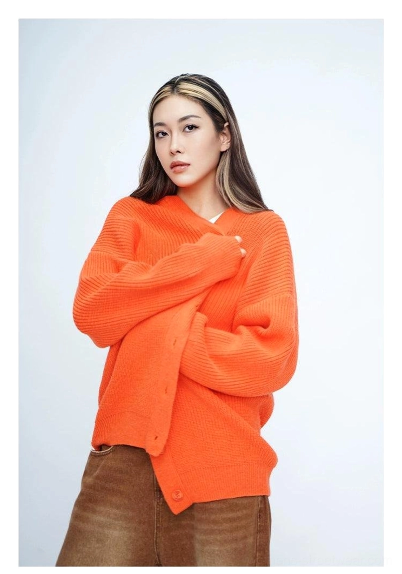 Orange oversized fuzzy ribbed knit cardigan front three quarter view with long drop shoulder sleeves