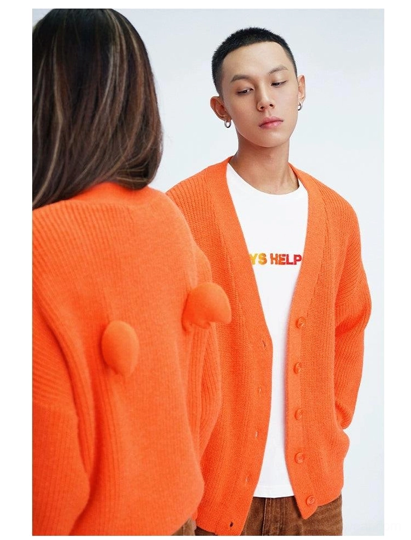 Orange oversized V-neck fuzzy knit cardigan with front buttons and pom-pom back design