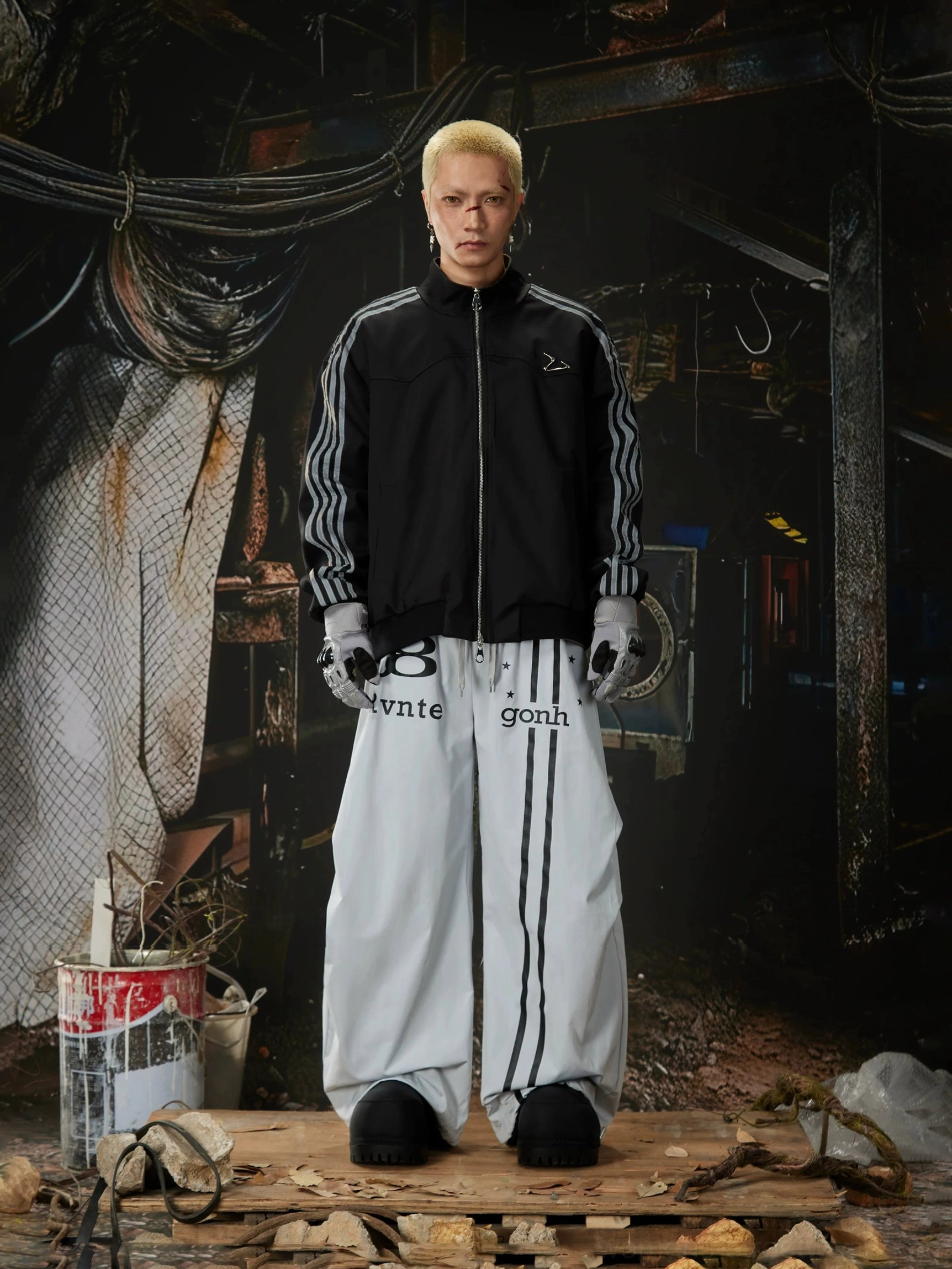 Oversized Astro Stripe track pants in a wide-leg streetwear design with relaxed proportions, sporty graphics, and everyday urban styling