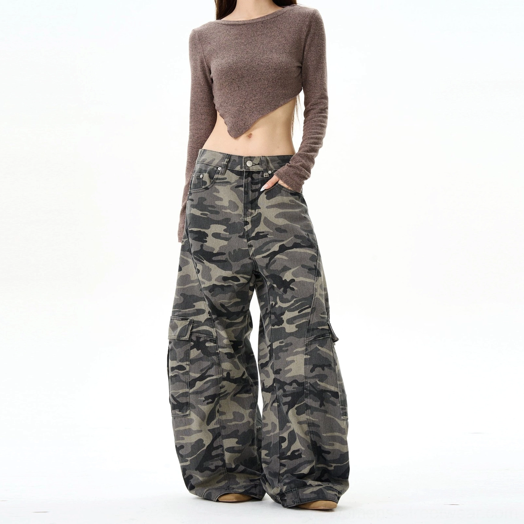 Low-angle front view of oversized baggy camouflage cargo pants with a full-length wide-leg cut and modern women's streetwear styling