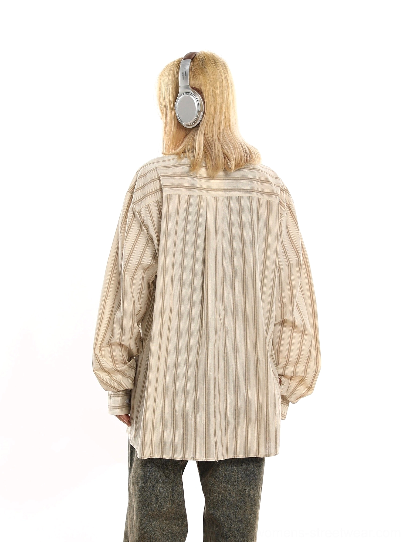 Back view of oversized beige pinstripe button-up shirt showing back pleat detail and roomy long sleeve fit