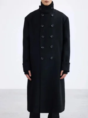 Front view of an oversized black double-breasted long overcoat with structured collar, wide cuffs, and minimalist Seoul streetwear styling