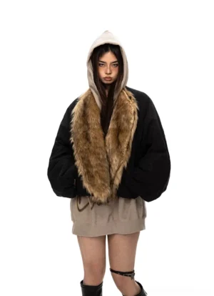 Oversized black flight jacket with brown faux fur collar layered over beige hoodie and mini skirt
