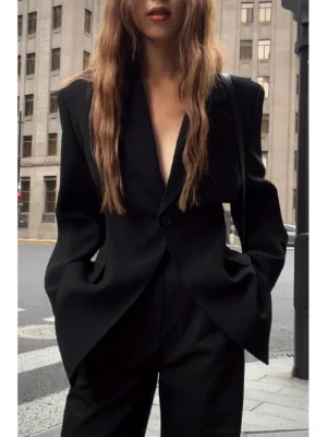 Oversized black single-button streetwear blazer jacket front close-up with structured padded shoulders and notched lapel