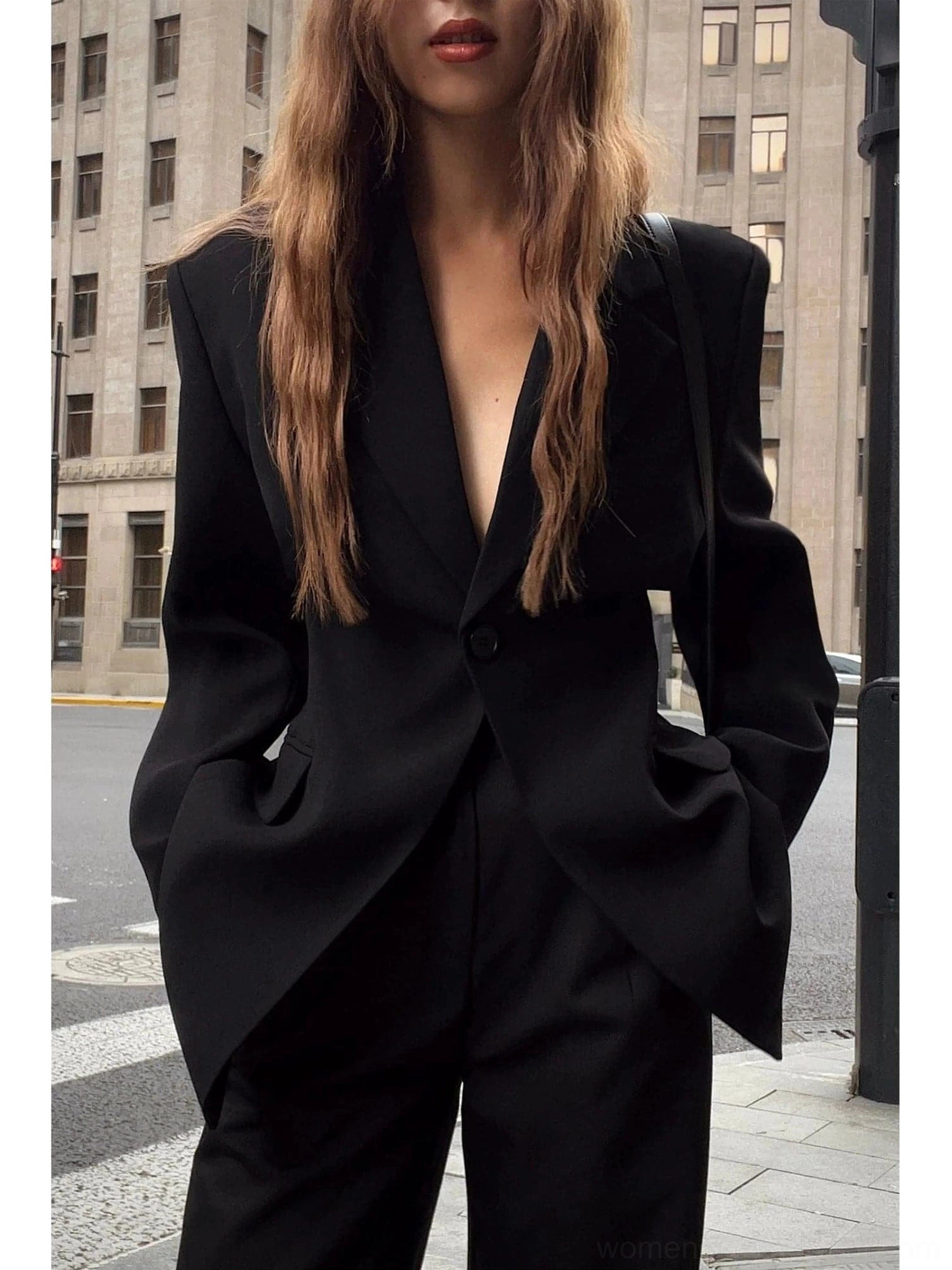 Oversized black single-button streetwear blazer jacket front close-up with structured padded shoulders and notched lapel