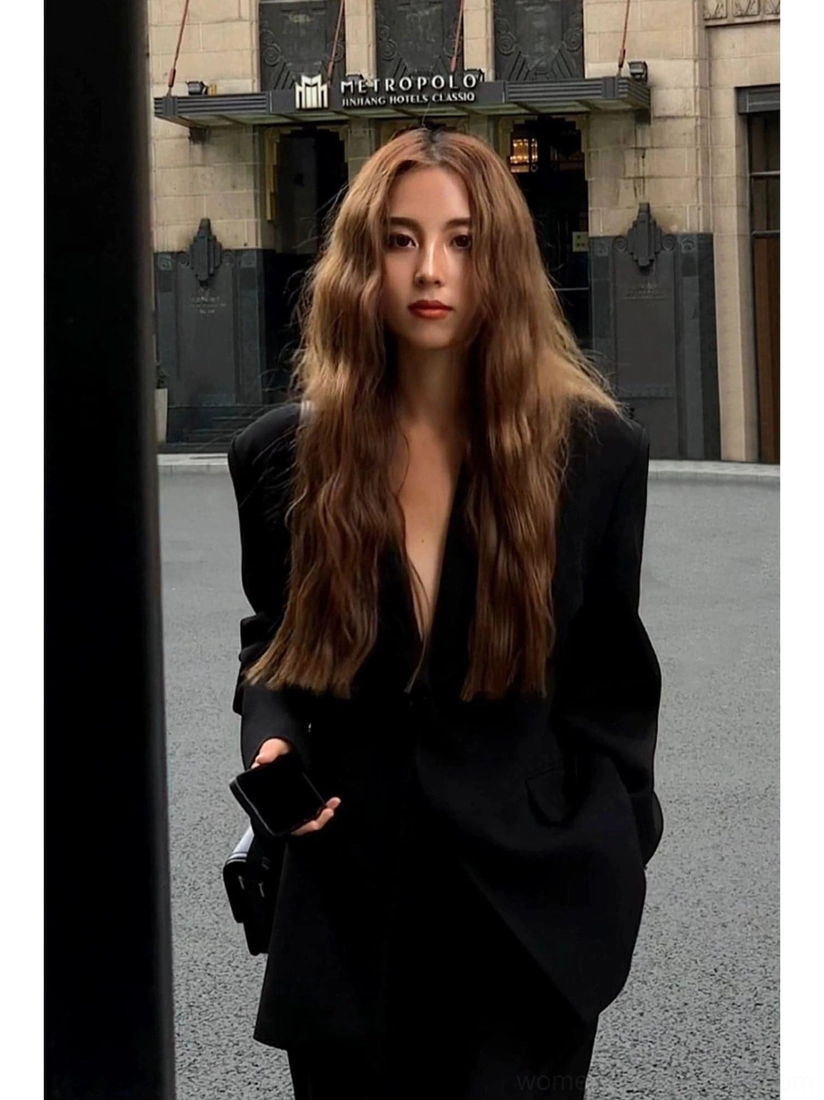 Women's black oversized blazer jacket front portrait showing deep V neckline relaxed fit and city style