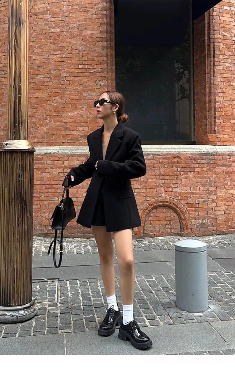 Oversized black streetwear blazer jacket showing elegant long sleeves and classic tailored design