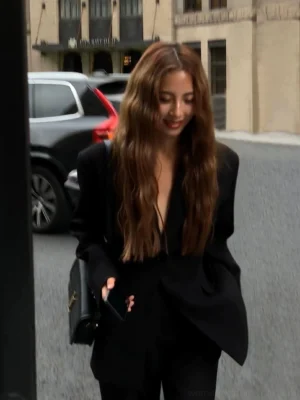 Women's oversized black streetwear blazer jacket worn open with deep V lapel and relaxed tailored silhouette