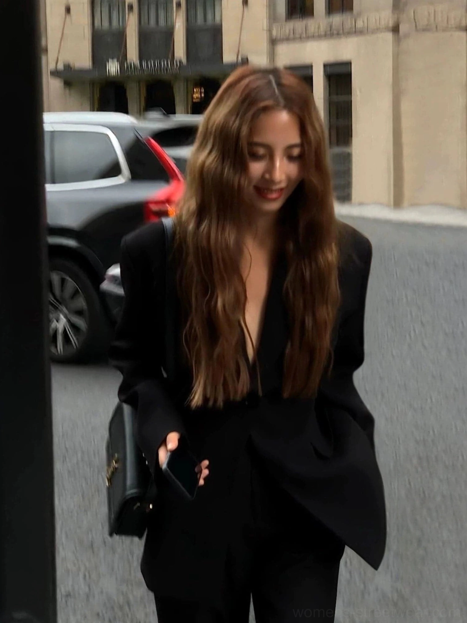 Women's oversized black streetwear blazer jacket worn open with deep V lapel and relaxed tailored silhouette