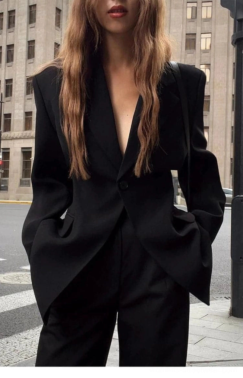 Women's oversized black blazer jacket showing relaxed longline streetwear tailoring