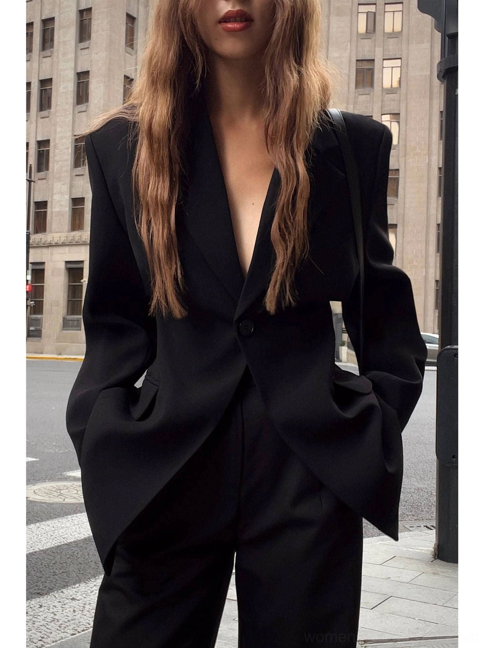 Oversized black streetwear blazer jacket paired with black wide-leg trousers in a modern monochrome outfit