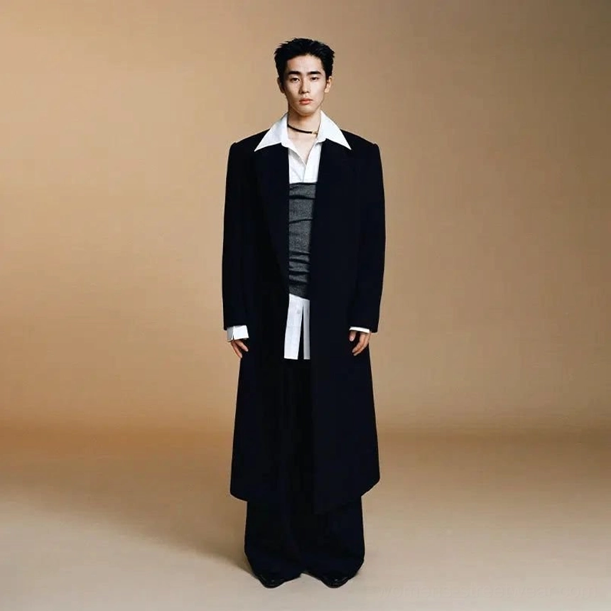 Full outfit featuring an oversized black wool long coat layered over a white shirt, grey vest, and wide-leg trousers