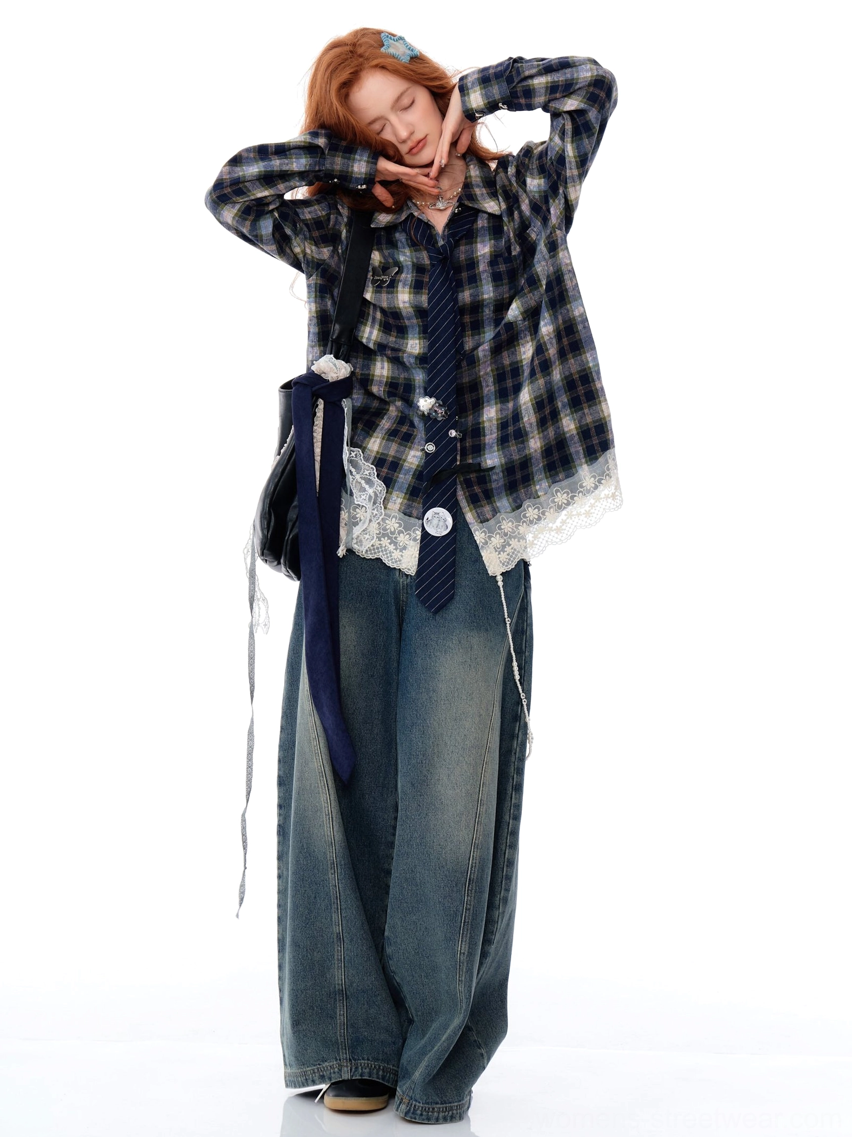 Side view of an oversized blue plaid lace hem shirt styled with wide-leg jeans and a matching necktie
