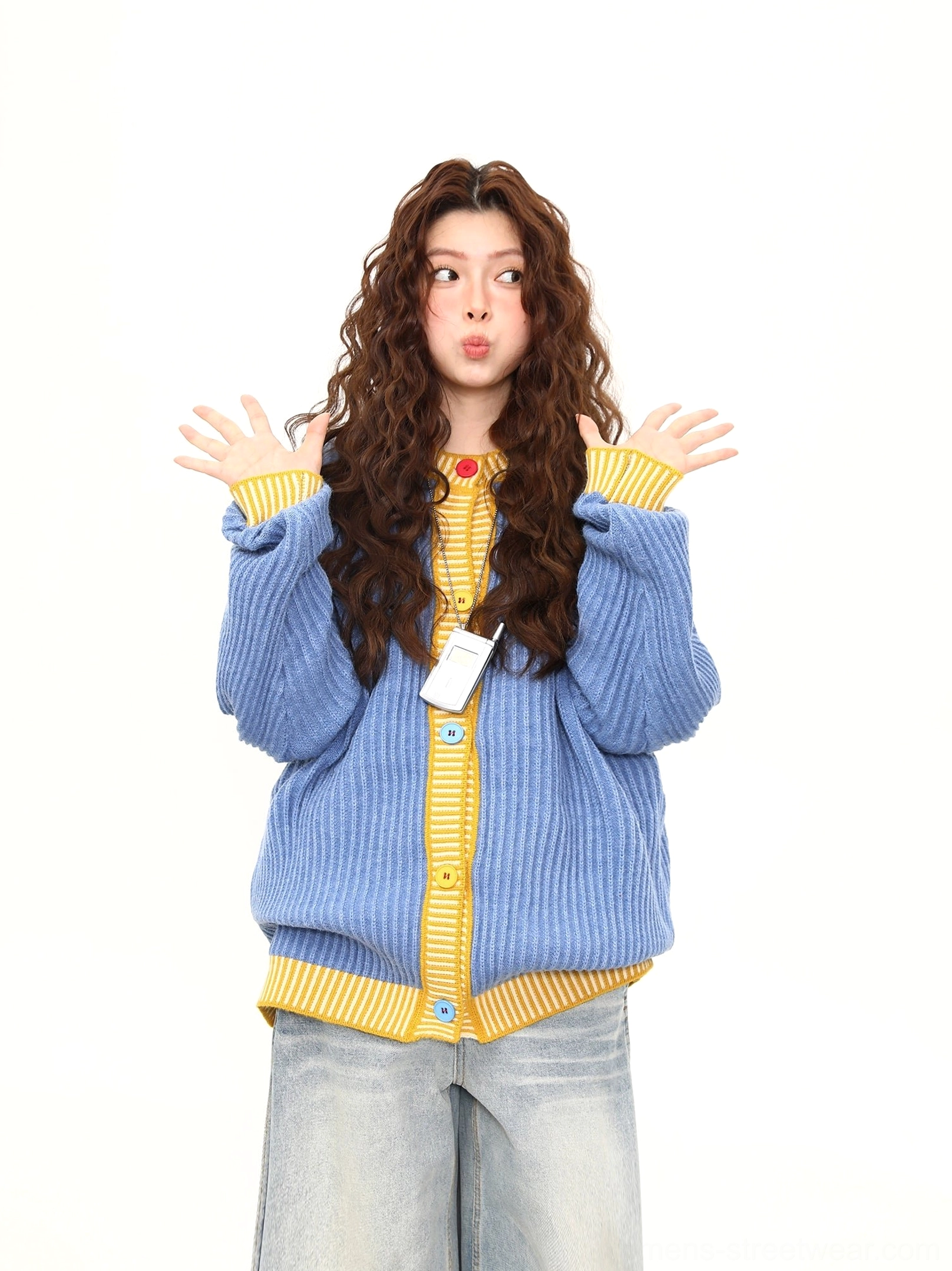 Front view of oversized blue and yellow ribbed knit cardigan with button closure and wide leg jeans