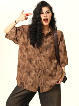 Front view of a women's oversized brown tie-dye grunge button-up shirt with relaxed streetwear fit and abstract vintage pattern