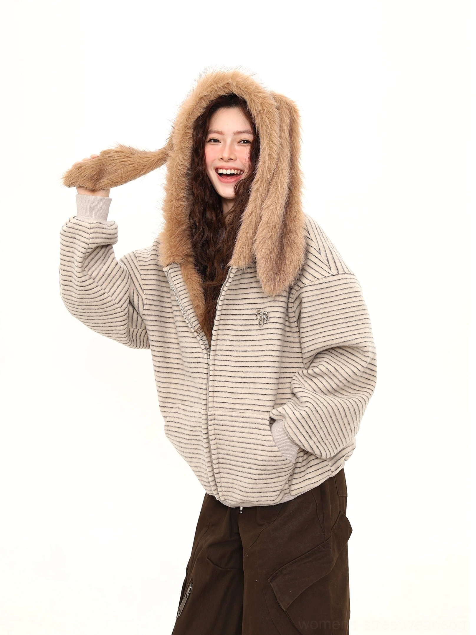 Three-quarter view of an oversized bunny-ear striped hoodie with front hand pockets, ribbed cuffs, ribbed hem, and plush faux-fur hood