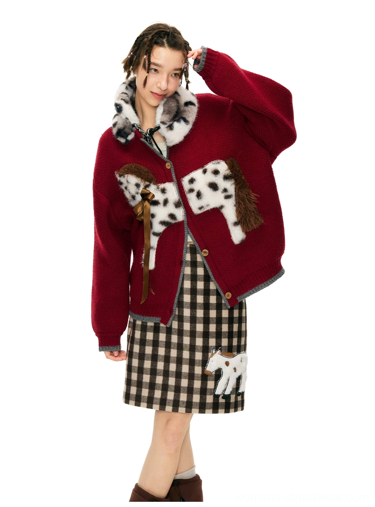 Close front view of oversized burgundy knit cardigan with dimensional spotted pony decoration
