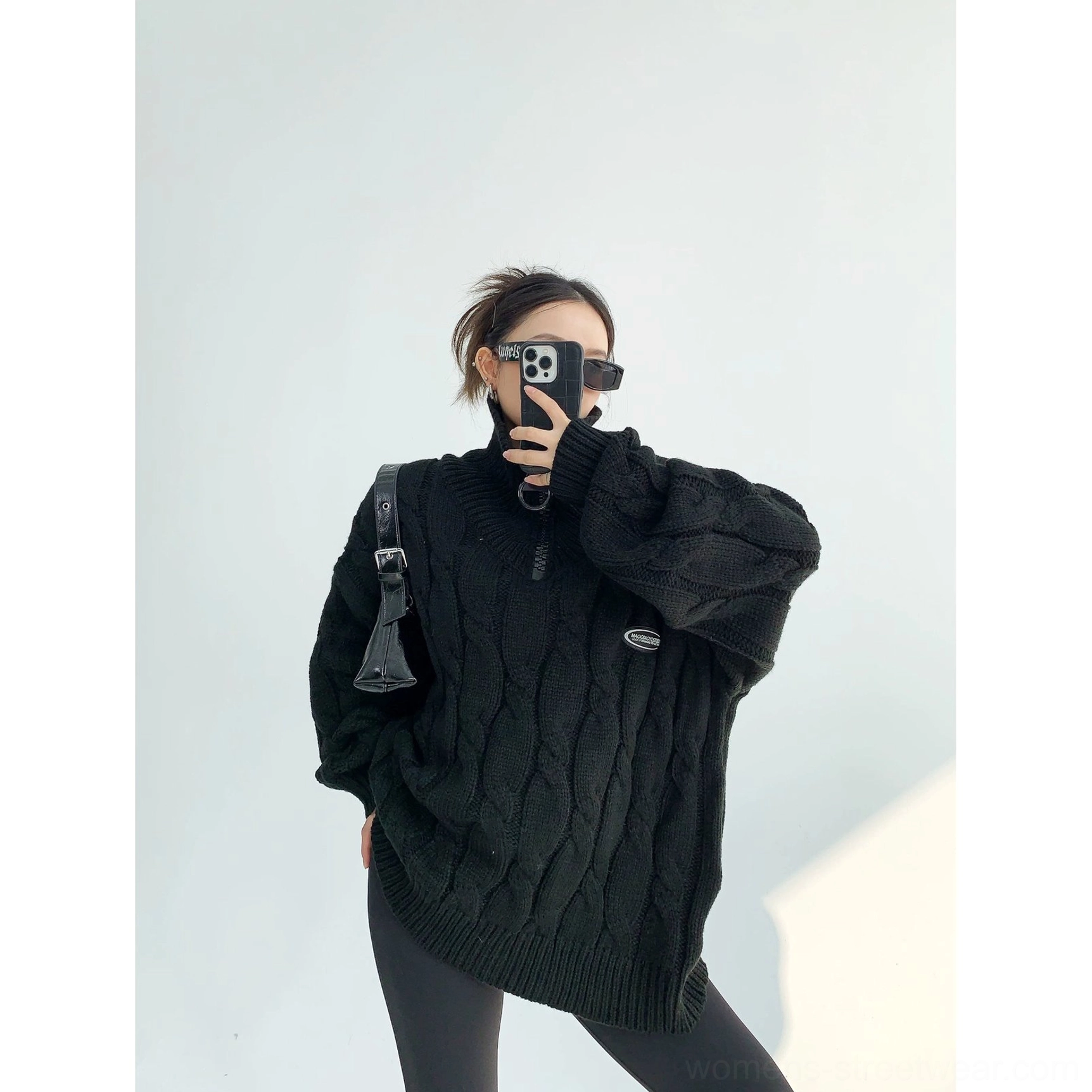 Black oversized cable knit quarter-zip sweater with stand collar and slouchy urban fit