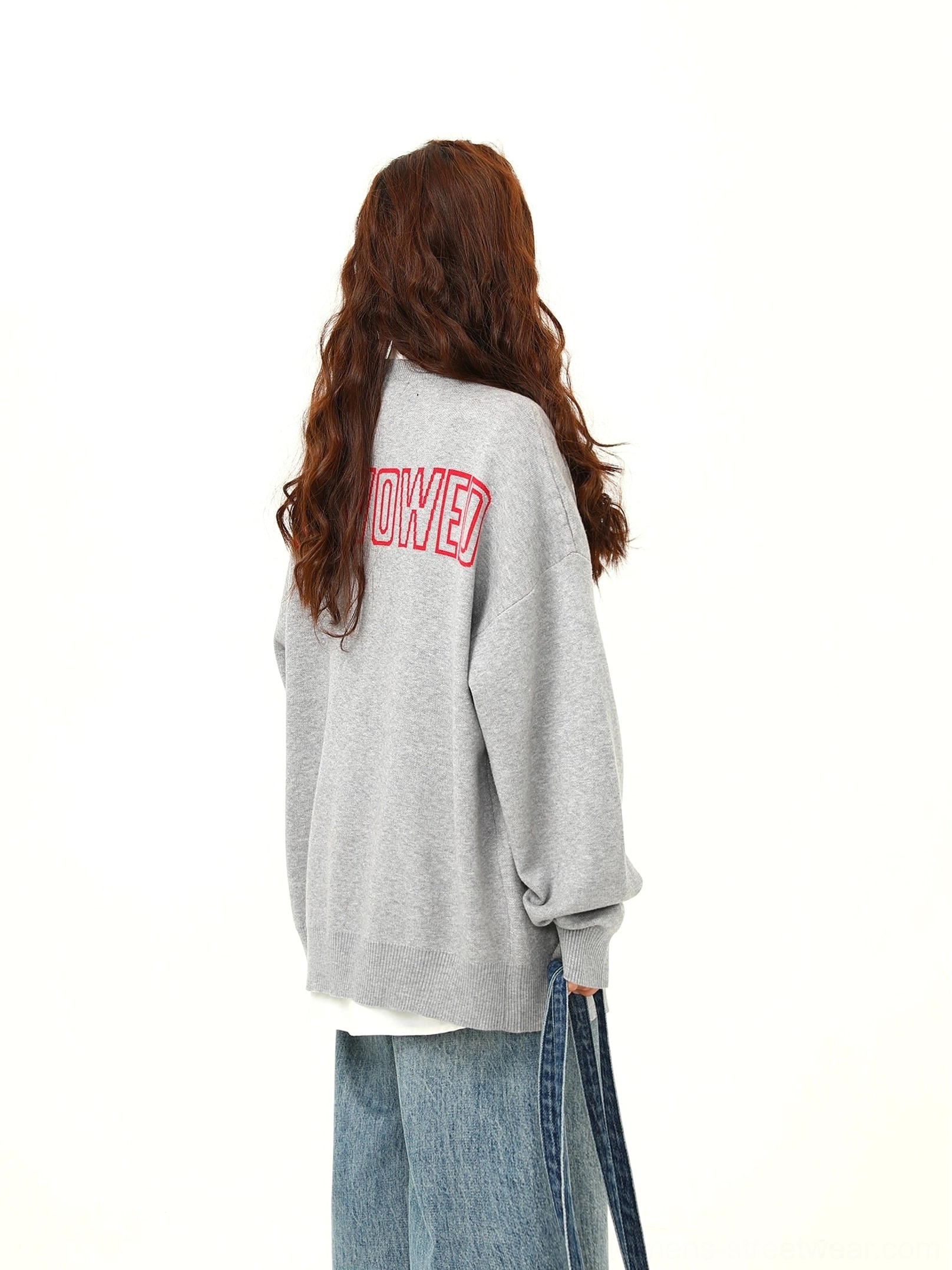 Back view of gray oversized cartoon puppy knit cardigan with red letter graphic and ribbed hem