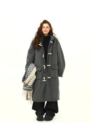 Front view of oversized charcoal gray hooded duffle coat with horn-style toggle fastenings and large patch pockets in Korean streetwear outfit