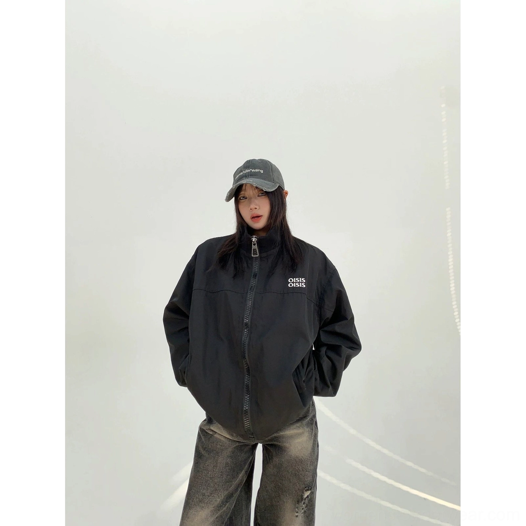 Black oversized cloud shell windbreaker jacket for women front view with hands in side pockets and loose Seoul streetwear fit