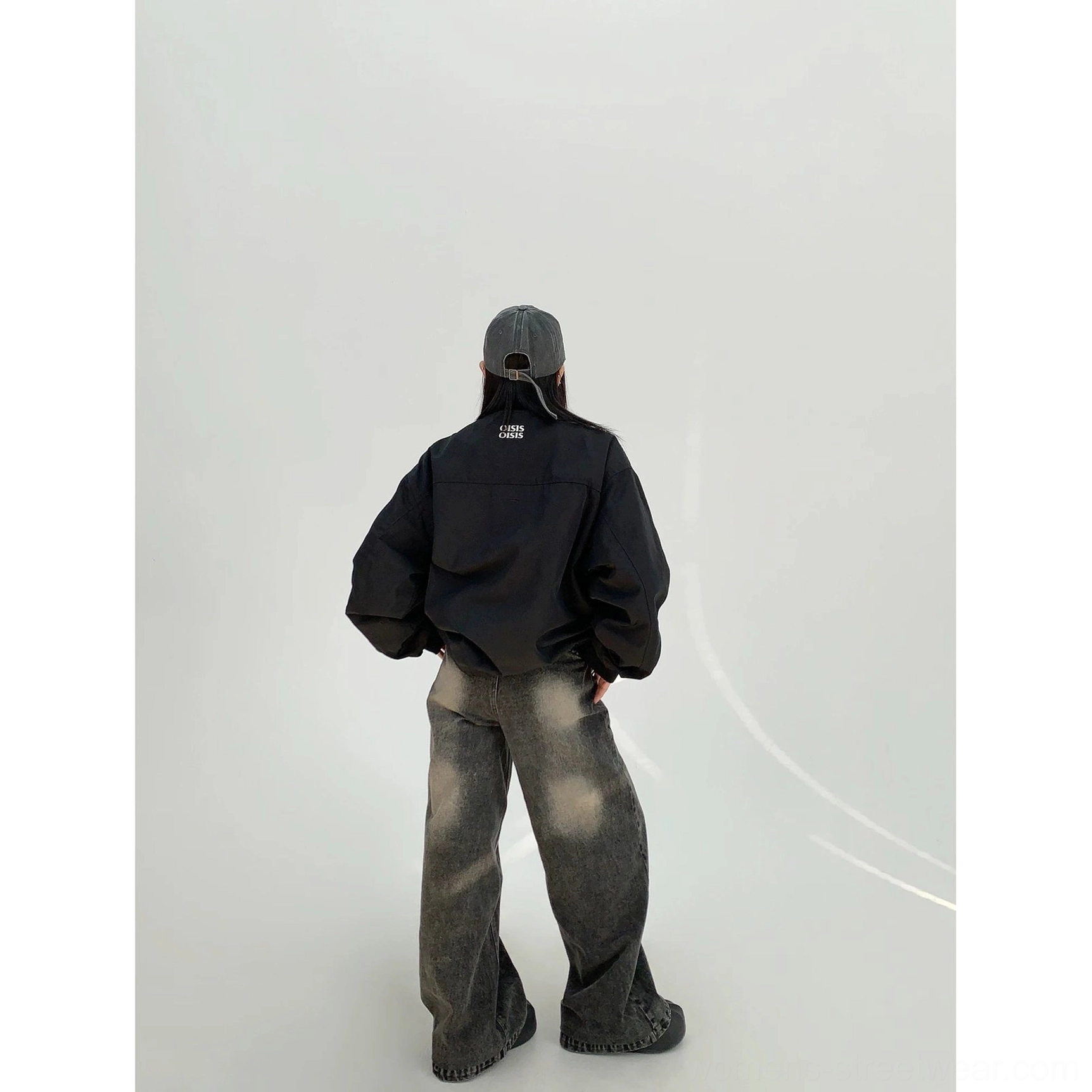 Black women's oversized cloud shell windbreaker jacket back view showing clean minimal back panel and elasticated hem