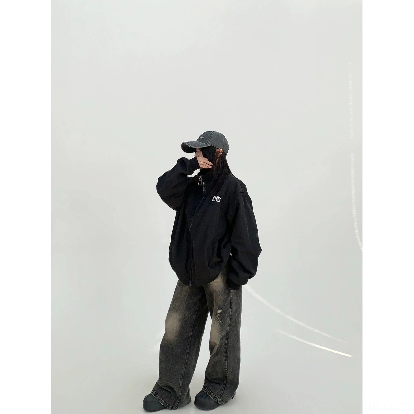 Black oversized cloud shell windbreaker jacket for women in side front view with full zip closure and relaxed streetwear styling