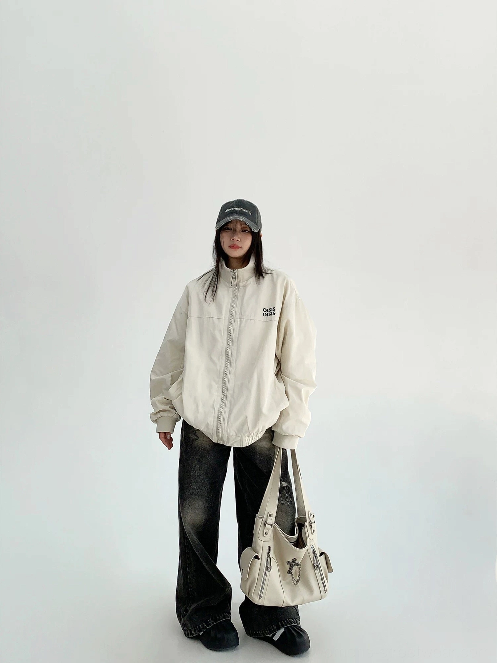 Off-white women's oversized cloud shell windbreaker jacket full front outfit view with zip front, stand collar, jeans and shoulder bag