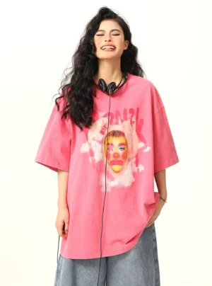 Front view of pink oversized clown graphic streetwear T-shirt with faded washed finish and face print