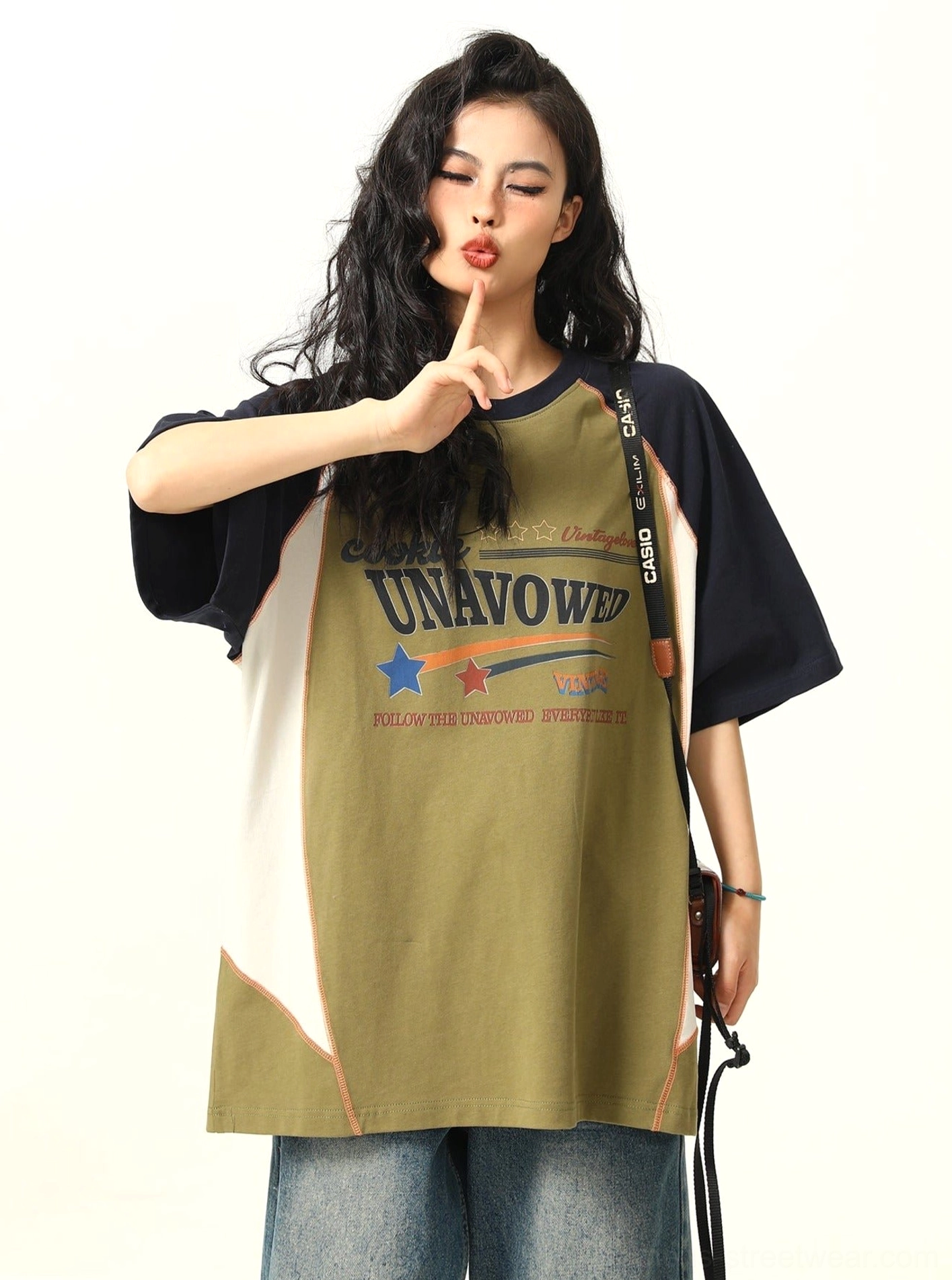 Green and navy oversized raglan T-shirt with white side panels and contrast stitching front three-quarter view