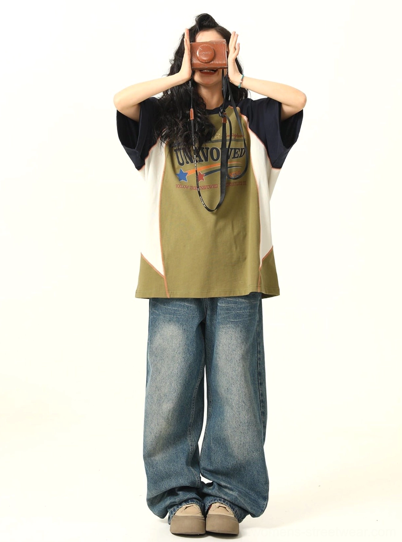 Olive oversized raglan graphic tee with white side colorblock panels styled with loose denim jeans