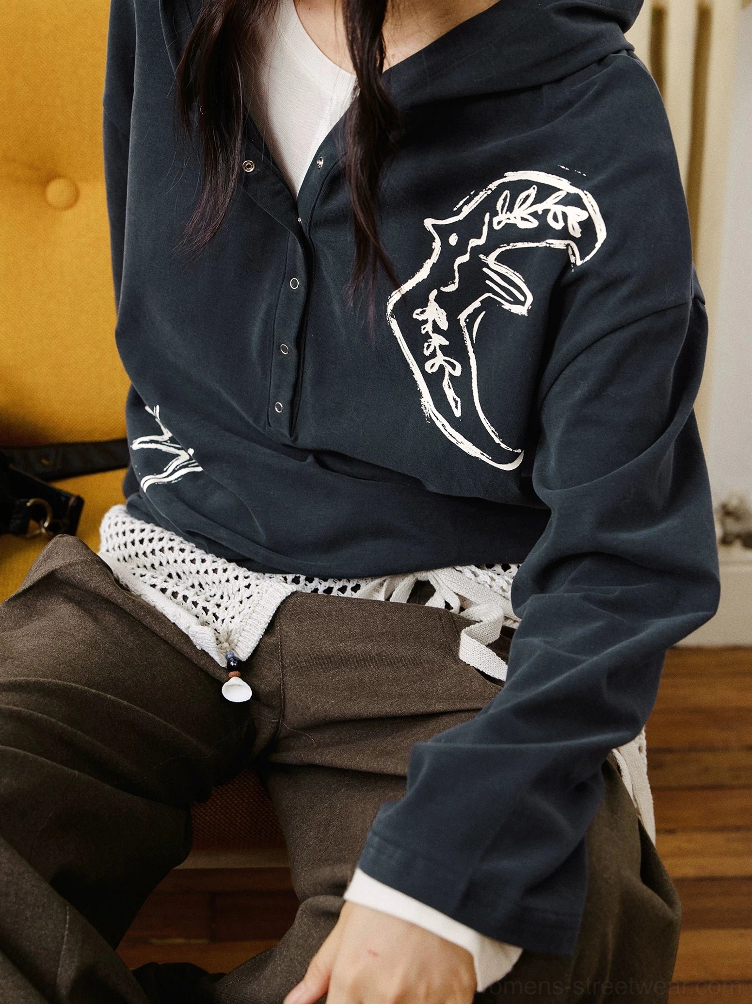 Close-up view of soft cotton oversized embroidered polo shirt showing detailed chest and side animal graphic embroidery
