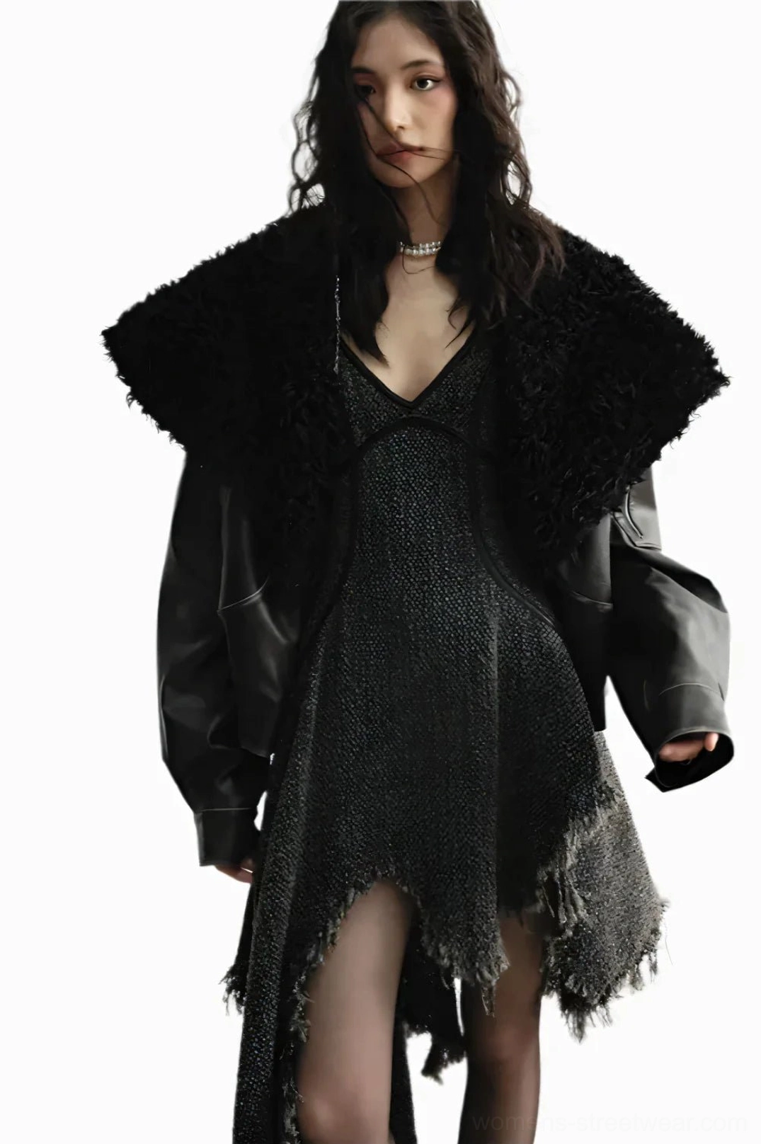 Woman wearing an oversized cropped faux fur aviator jacket with a pearl choker and relaxed sleeves