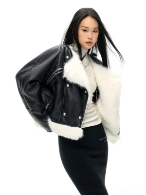 Side back view of an oversized cropped faux leather jacket with faux shearling trim and double breasted snap closure