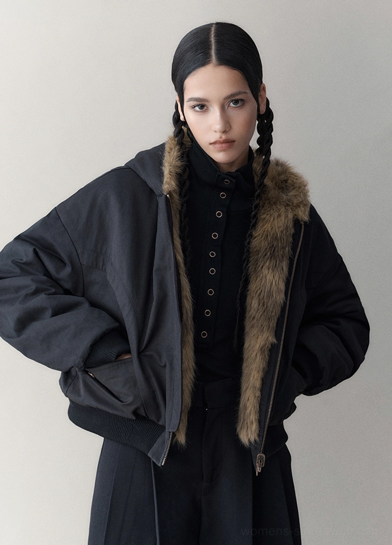 Front view of an oversized cropped black reversible faux fur jacket with zip closure, soft collar, and relaxed bomber silhouette