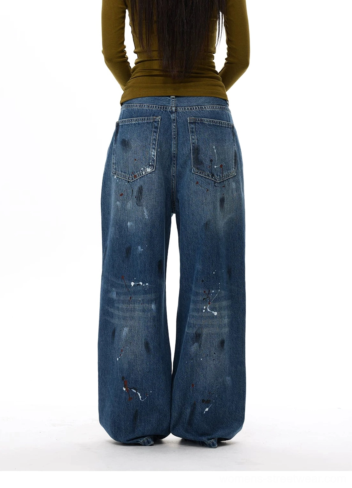 Oversized distressed denim jeans with paint splatter finish, open knee rips, and contemporary Seoul streetwear influence